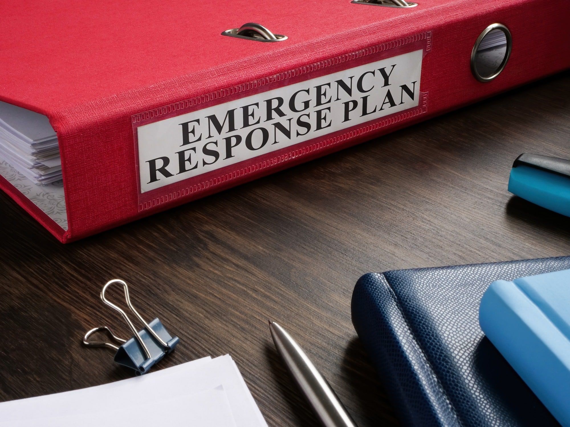 Red folder with emergency response plan on the desk